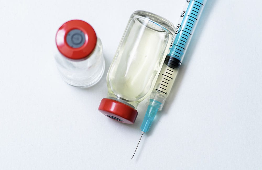 Untitled-3_0001_close-up-of-syringe-and-vials-on-white-table-2024-09-22-22-36-59-utc
